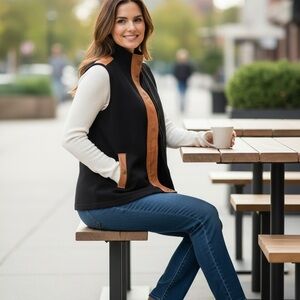 Black vest with brown leather trim.